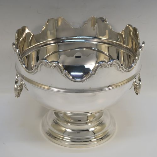 A very handsome Antique Sterling Silver Montieth style rose bowl, having a round plain body, an applied scroll top border above a reeded band, with two cast and hinged side-handles, and all sitting on a pedestal foot. This elegant antique silver rose bowl montieth was made by the Deakin Brothers of Sheffield in 1912. The dimensions of this fine hand-made antique silver rose Montieth bowl are height 17.5 cms (7 inches), diameter 21 cms (8.25 inches), and it weighs approx. 926g (29.9 troy ounces).   