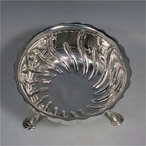 An Antique Victorian Sterling Silver bowl, having a round body, with hand-chased swirl half-fluting, a shaped pie-crust border, and all sitting on three cast hoof feet with shell shoulders. Made by the Barnard Brothers of London in 1888. The dimensions of this fine hand-made antique silver bowl are height 7 cms (2.75 inches), diameter 13 cms (5.25 inches), and it weighs approx. 195g (6.3 troy ounces).    