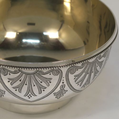 A very pretty Antique Victorian Sterling Silver bowl, having a round body with hand-engraved floral and scroll-work decoration, an applied bead-edged top border, a gold-gilt interior, and sitting on collet foot. This beautiful antique silver bowl was made by George Adams of London in 1880. The dimensions of this fine hand-made antique silver bowl are height 6 cms (2.25 inches), diameter 11.5 cms (4.5 inches), and it weighs approx. 143g (4.6 troy ounces).  