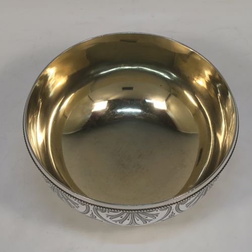 A very pretty Antique Victorian Sterling Silver bowl, having a round body with hand-engraved floral and scroll-work decoration, an applied bead-edged top border, a gold-gilt interior, and sitting on collet foot. This beautiful antique silver bowl was made by George Adams of London in 1880. The dimensions of this fine hand-made antique silver bowl are height 6 cms (2.25 inches), diameter 11.5 cms (4.5 inches), and it weighs approx. 143g (4.6 troy ounces).  