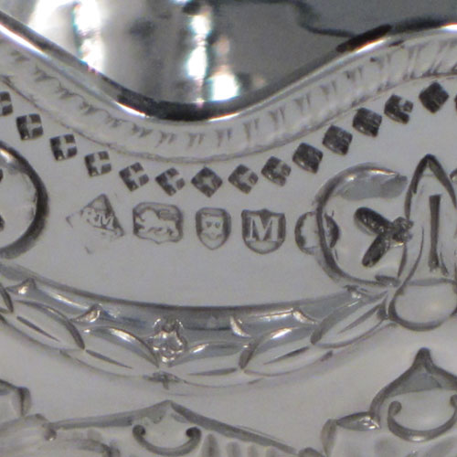 Antique Victorian sterling silver set of four bowls, having round bodies with hand-chased neoclassical style decoration showing bows, swags, and anthemion leaves, applied wavey gadroon borders, and sitting on hand-chased pedestal feet. Made by Martin and Hall of London in 1887. The dimensions of these fine hand-made silver bowls are diameter 13 cms (5 inches), height 6.5 cms (2.5 inches), and they weigh a total of 695g (22 troy ounces).