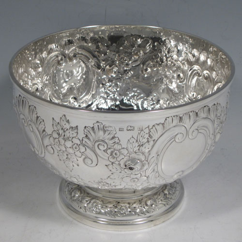 Antique Edwardian sterling silver rose bowl, having a round body with hand-chased floral decoration, two vacant cartouches, and sitting on a pedestal foot. Made by Elkington and Co., of Birmingham in 1903. The dimensions of this fine hand-made silver rose bowl are height 11 cms (4.25 inches), diameter 15 cms (6 inches), and the total weight is approx. 326g (10.5 troy ounces).