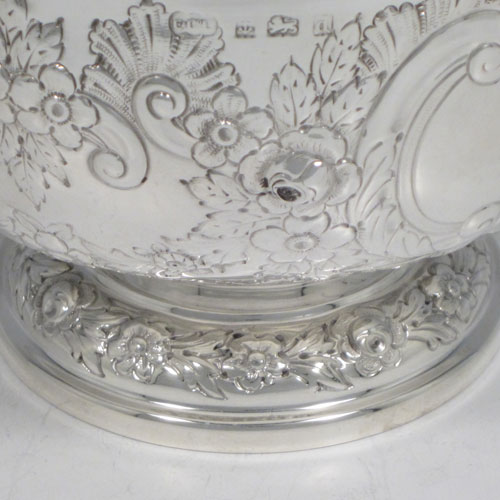 Antique Edwardian sterling silver rose bowl, having a round body with hand-chased floral decoration, two vacant cartouches, and sitting on a pedestal foot. Made by Elkington and Co., of Birmingham in 1903. The dimensions of this fine hand-made silver rose bowl are height 11 cms (4.25 inches), diameter 15 cms (6 inches), and the total weight is approx. 326g (10.5 troy ounces).