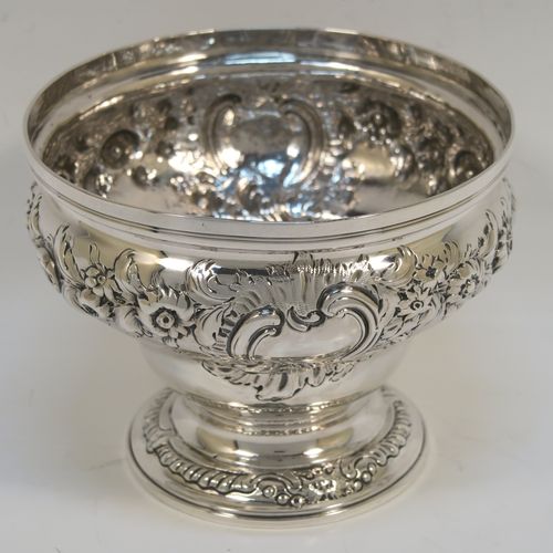 A rare and very pretty Antique Georgian George II Sterling Silver small rose bowl, having a round body with hand-chased floral decoration surrounding two cartouches on either side, and sitting on a round pedestal foot. This beautiful antique silver bowl was made by Thomas Whipham and Charles Wright of London in 1758. The dimensions of this fine hand-made antique silver rose bowl are height 9.5 cms (3.75 inches), diameter 12.5 cms (5 inches), with a weight of approx. 271g (8.7 troy ounces). Please note that one of the cartouches is engraved with a contemporaneous set of initials. 