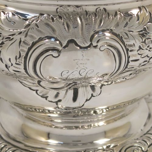 A rare and very pretty Antique Georgian George II Sterling Silver small rose bowl, having a round body with hand-chased floral decoration surrounding two cartouches on either side, and sitting on a round pedestal foot. This beautiful antique silver bowl was made by Thomas Whipham and Charles Wright of London in 1758. The dimensions of this fine hand-made antique silver rose bowl are height 9.5 cms (3.75 inches), diameter 12.5 cms (5 inches), with a weight of approx. 271g (8.7 troy ounces). Please note that one of the cartouches is engraved with a contemporaneous set of initials. 