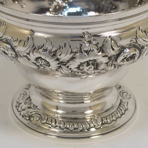 A rare and very pretty Antique Georgian George II Sterling Silver small rose bowl, having a round body with hand-chased floral decoration surrounding two cartouches on either side, and sitting on a round pedestal foot. This beautiful antique silver bowl was made by Thomas Whipham and Charles Wright of London in 1758. The dimensions of this fine hand-made antique silver rose bowl are height 9.5 cms (3.75 inches), diameter 12.5 cms (5 inches), with a weight of approx. 271g (8.7 troy ounces). Please note that one of the cartouches is engraved with a contemporaneous set of initials. 