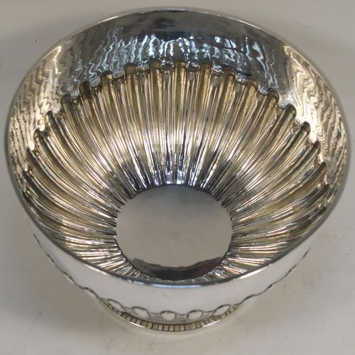 A very handsome Antique Victorian Sterling Silver small Rose bowl, having a round body with hand-chased half-fluted decoration, an applied reeded top border, and sitting on a round pedestal foot. This elegant antique silver rose bowl was made by Frederick Burridge of London in 1898. The dimensions of this fine hand-made silver bowl are height 8.5 cms (3.3 inches), diameter 13.5 cms (5.3 inches), and it weighs approx. 178g (5.7 troy ounces).   