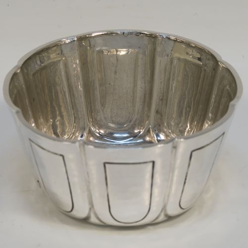 A heavy and handsome Antique Edwardian Sterling Silver small bowl, having a round bellied body with a hand-hammered finish, together with hand-chased panel decoration, and all sitting on a concave base. This elegant antique silver bowl was made by the William Comyns of London in 1904. The dimensions of this fine hand-made silver bowl are height 5 cms (2 inches), diameter 10 cms (4 inches), and it weighs approx. 222g (7.2 troy ounces).   