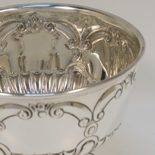 A very pretty Sterling Silver small Rose bowl, having a round bellied body with hand-chased scroll and half fluted decoration, and sitting on a pedestal foot. This beautiful silver rose bowl was made by the Charles Weale of Birmingham in 1929. The dimensions of this fine hand-made silver bowl are height 9 cms (3.5 inches), diameter 11.5 cms (4.5 inches), and it weighs approx. 180g (5.8 troy ounces).   