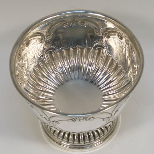 A very pretty Sterling Silver small Rose bowl, having a round bellied body with hand-chased scroll and half fluted decoration, and sitting on a pedestal foot. This beautiful silver rose bowl was made by the Charles Weale of Birmingham in 1929. The dimensions of this fine hand-made silver bowl are height 9 cms (3.5 inches), diameter 11.5 cms (4.5 inches), and it weighs approx. 180g (5.8 troy ounces).   