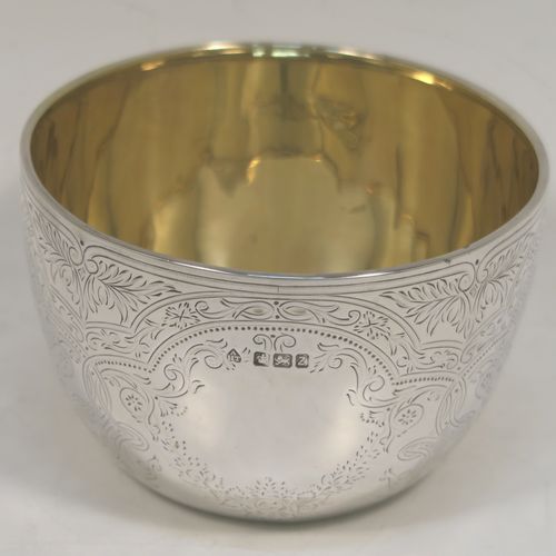 A very pretty Antique Victorian Sterling Silver bowl, having a round body with hand-engraved floral and scroll-work decoration, a gold-gilt interior, and sitting on a flat base. This beautiful antique silver bowl was made by Albert Henry Thompson of Sheffield in 1892. The dimensions of this fine hand-made antique silver bowl are height 6.5 cms (2.75 inches), diameter 10 cms (4 inches), and it weighs approx. 132g (4.3 troy ounces).

   