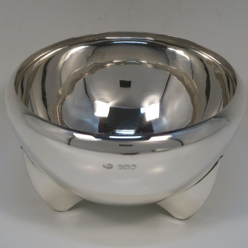 A handsome Art Deco style Sterling Silver bowl, having a very plain round body with tapering sides and folded over rim, sitting on three fin-style panelled feet. This elegant silver bowl was made by James Round of Sheffield in 1934. The dimensions of this fine hand-made Art Deco silver bowl are diameter 15 cms (6 inches), height 9 cms (3.5 inches), and it weighs approx. 218g (7 troy ounces).  