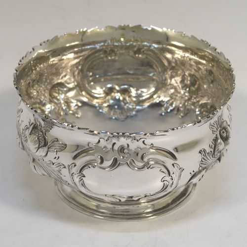 A very pretty Antique Victorian Sterling Silver small rose bowl, having a round body with hand-chased fruit and floral decoration surrounding two vacant cartouches on either side, and sitting on a pedestal foot. This beautiful antique silver bowl was made by Daniel and Charles Houle of London in 1856. The dimensions of this fine hand-made antique silver rose bowl are height 7.5 cms (3 inches), diameter 12.5 cms (5 inches), with a weight of approx. 262g (8.5 troy ounces).  