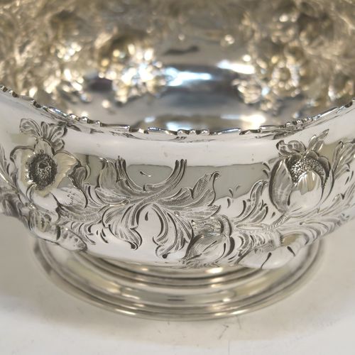 A very pretty Antique Victorian Sterling Silver small rose bowl, having a round body with hand-chased fruit and floral decoration surrounding two vacant cartouches on either side, and sitting on a pedestal foot. This beautiful antique silver bowl was made by Daniel and Charles Houle of London in 1856. The dimensions of this fine hand-made antique silver rose bowl are height 7.5 cms (3 inches), diameter 12.5 cms (5 inches), with a weight of approx. 262g (8.5 troy ounces).  