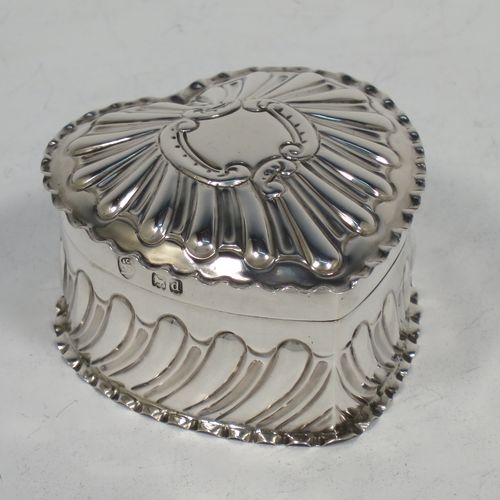 A very pretty Antique Victorian Sterling Silver heart-shaped table box, having a gold-gilt interior, all hand-chased with scroll-work, a hinged lid with vacant cartouche, and all sitting on a flat base. Made by Streeter and Co. Ltd., of London in 1899. The dimensions of this fine hand-made antique silver box are length 6 cms (2.3 inches), width 6 cms (2.3 inches), height 4 cms (1.5 inches), and it weighs approx. 49g (1.6 troy ounces).    