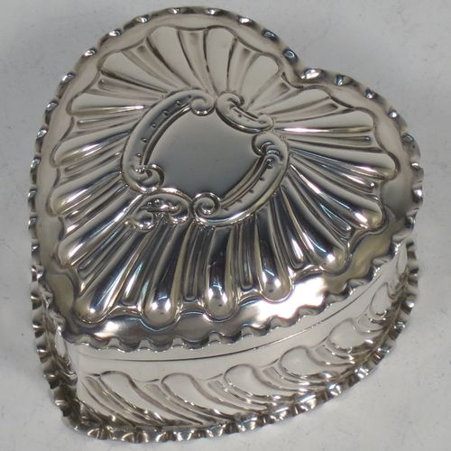 A very pretty Antique Victorian Sterling Silver heart-shaped table box, having a gold-gilt interior, all hand-chased with scroll-work, a hinged lid with vacant cartouche, and all sitting on a flat base. Made by Streeter and Co. Ltd., of London in 1899. The dimensions of this fine hand-made antique silver box are length 6 cms (2.3 inches), width 6 cms (2.3 inches), height 4 cms (1.5 inches), and it weighs approx. 49g (1.6 troy ounces).    