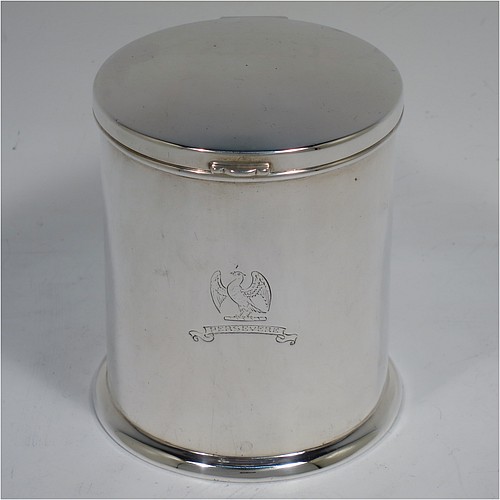 A very handsome Sterling Silver table box, having a round and straight-sided body with a hinged and slightly domed lid, with applied reed borders and thumb-piece, and sitting on a collet foot. Made by Ollivant and Bottisford of Sheffield in 1931. The dimensions of this fine hand-made silver box are diameter 8 cms (3 inches), height 9 cms (3.5 inches), and it weighs approx. 276g (8.9 troy ounces). Please note that this item is crested.   