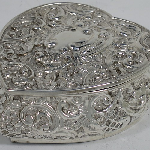 A very pretty Antique Victorian Sterling Silver heart-shaped table box, having a  gold-gilt interior, all hand-chased with flowers and scroll-work, and sitting on a flat base. Made by Henry Matthews of Birmingham in 1908. The dimensions of this fine hand-made antique silver box are length 10 cms (4 inches), width 9 cms (3.5 inches), height 4 cms (1.5 inches), and it weighs approx. 96g (3 troy ounces).    