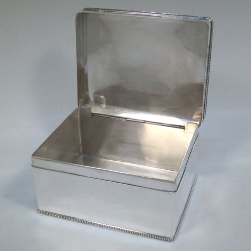 A very elegant and simple Sterling Silver table box, having a plain rectangular body with straight sides and applied gadroon borders, a hinged lid, and sitting of a flat base. Made by Hukin and Heath of Birmingham in 1937. The dimensions of this fine hand-made silver table box are length 15 cms (6 inches), width 11.5 cms (4.5 inches), height 7.5 cms (3 inches), and it weighs approx. 588g (19 troy ounces)  