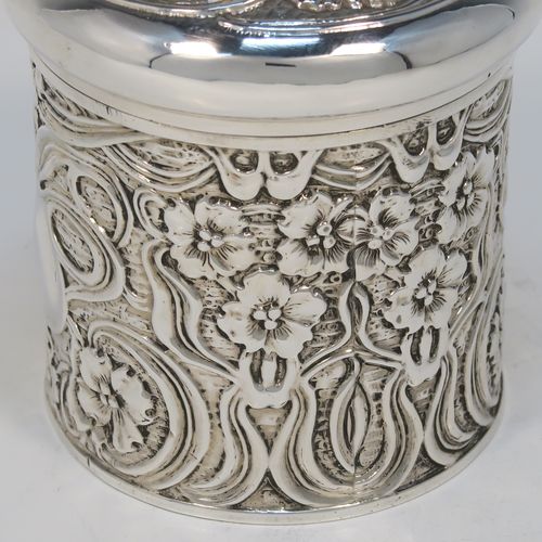 A very pretty Antique Edwardian Sterling Silver Art Nouveau style table box, having a round straight-sided body with hand-chased floral and scroll decoration, a pull-off lid with matching decoration and vacant central cartouche, a gold-gilt interior, and all sitting on a flat base. This beautiful Art Nouveau silver box was made by Synyer and Beddoes of Birmingham in 1903. The dimensions of this fine hand-made antique silver Art Nouveau style box are height 9 cms (3.5 inches), diameter 8 cms (3.25 inches), and it weighs approx. 130g (4.2 troy ounces).   