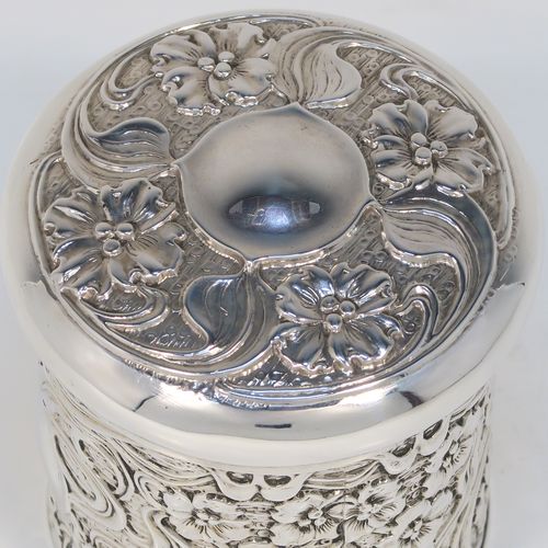 A very pretty Antique Edwardian Sterling Silver Art Nouveau style table box, having a round straight-sided body with hand-chased floral and scroll decoration, a pull-off lid with matching decoration and vacant central cartouche, a gold-gilt interior, and all sitting on a flat base. This beautiful Art Nouveau silver box was made by Synyer and Beddoes of Birmingham in 1903. The dimensions of this fine hand-made antique silver Art Nouveau style box are height 9 cms (3.5 inches), diameter 8 cms (3.25 inches), and it weighs approx. 130g (4.2 troy ounces).   