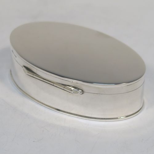 A very elegant and simple Antique Sterling Silver table box, having a plain oval body with straight sides, a hinged lid, a gold-gilt interior, and sitting of a flat base. This handsome silver box was made by Deakin and Francis of Birmingham in 1913. The dimensions of this fine hand-made antique silver table box are length 10 cms (4 inches), width 6 cms (2.25 inches), height 3 cms (1.25 inches), and it weighs approx. 99g (3 troy ounces)   