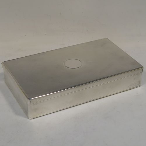 A very elegant Antique Victorian Sterling Silver  table or desk box, having a rectangular body with engine-turned decoration, a vacant round cartouche on the hinged lid, a compartmentalised interior, and all sitting of a flat base. This handsome antique silver box was made by Charles and George Asprey of London in 1896. The dimensions of this fine hand-made antique silver table box are length 18.5 cms (7.25 inches), width 11 cms (4.25 inches), height 3.5 cms (1.3 inches), and it weighs approx. 569g (18.4 troy ounces)  