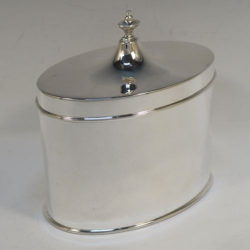 A large and very handsome Antique Edwardian Silver Plated table box, having a very plain oval body with straight sides, a hinged lid with a cast urn-shaped finial, and all sitting on a flat base. This elegant antique table box was made in ca. 1910. The dimensions of this fine hand-made antique silver-plated table box are height 17 cms (6.75 inches), width 17 cms (6.75 inches), and depth 10 cms (4 inches).  