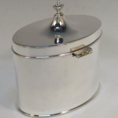 A large and very handsome Antique Edwardian Silver Plated table box, having a very plain oval body with straight sides, a hinged lid with a cast urn-shaped finial, and all sitting on a flat base. This elegant antique table box was made in ca. 1910. The dimensions of this fine hand-made antique silver-plated table box are height 17 cms (6.75 inches), width 17 cms (6.75 inches), and depth 10 cms (4 inches).  