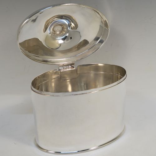 A large and very handsome Antique Edwardian Silver Plated table box, having a very plain oval body with straight sides, a hinged lid with a cast urn-shaped finial, and all sitting on a flat base. This elegant antique table box was made in ca. 1910. The dimensions of this fine hand-made antique silver-plated table box are height 17 cms (6.75 inches), width 17 cms (6.75 inches), and depth 10 cms (4 inches).  