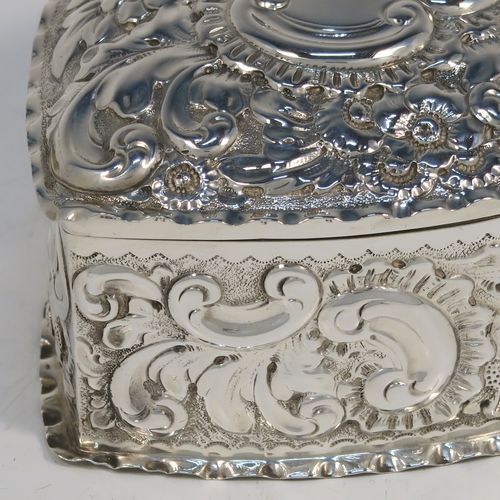 A very pretty Antique Victorian Sterling Silver heart-shaped table box, having a gold-gilt interior, all hand-chased with floral and scroll-work, a hinged lid with vacant cartouche, and all sitting on a flat base. This beautiful silver box was made by Deakin and Francis of Birmingham in 1893. The dimensions of this fine hand-made antique silver hear-shaped box are length 9 cms (3.5 inches), width 8 cms (3.25 inches), height 5 cms (2 inches), and it weighs approx. 96g (3 troy ounces).   