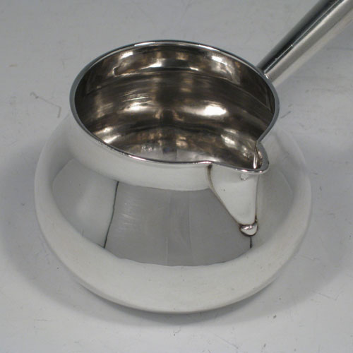    Antique Georgian sterling silver brandy sauce pan with wooden handle. Hallmarked for London in 1724. Length 23 cms (9