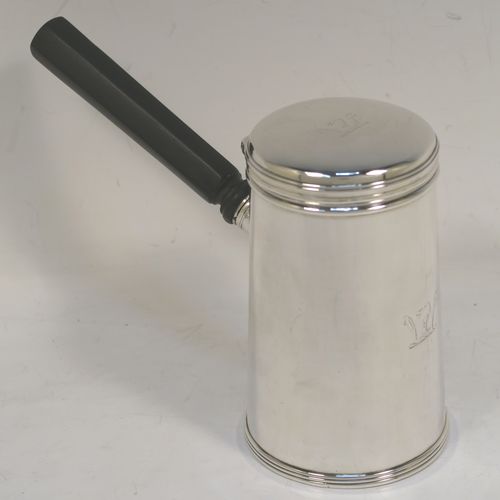 A very unusual and handsome Antique Victorian Sterling Silver brandy or sauce warmer, having a plain round body with tapering sides and reeded borders, a panelled wood turned side handle, a flat hinged lid, and all sitting on a flat base. This elegant antique silver brandy or sauce warmer was made by Alfred Brownett for Aspreys of London in 1866. The dimensions of this fine hand-made brandy sauce warmer are height of main body 11 cms (4.3 inches), diameter at base 7 cms (2.75 inches), length (inc. handle) 15 cms (6 inches), and it weighs approx. 210g (6.8 troy ounces). Please note that this item is crested. 