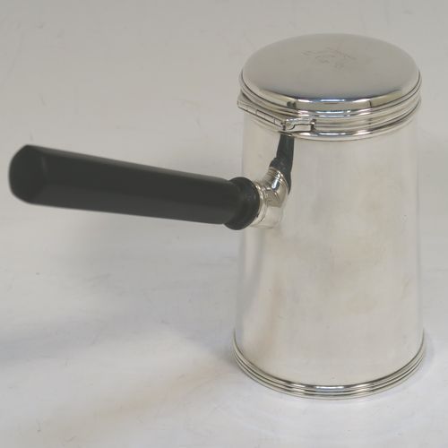 A very unusual and handsome Antique Victorian Sterling Silver brandy or sauce warmer, having a plain round body with tapering sides and reeded borders, a panelled wood turned side handle, a flat hinged lid, and all sitting on a flat base. This elegant antique silver brandy or sauce warmer was made by Alfred Brownett for Aspreys of London in 1866. The dimensions of this fine hand-made brandy sauce warmer are height of main body 11 cms (4.3 inches), diameter at base 7 cms (2.75 inches), length (inc. handle) 15 cms (6 inches), and it weighs approx. 210g (6.8 troy ounces). Please note that this item is crested. 