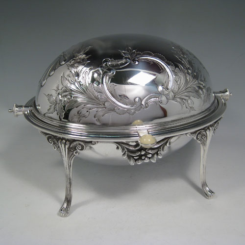    Antique Victorian silver plated revolving breakfast dish with hand-chased floral decoration, cast foliate feet, and original liners. Made by James Round of Sheffield in ca. 1880. Height 21.5 cms (8.5 inches), length 33 cms (13 inches), width 23 cms (9 inches).