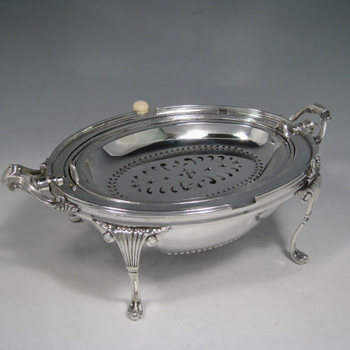 Antique Victorian silver-plated breakfast dish with revolving lid, original liners, and having hand-chased half-fluted body, sitting on four cast fluted feet. Made by the Mappin Brothers of Sheffield in ca. 1890. Height 21 cms (8.25 inches), length 35.5 cms (14 inches), width 21.5 cms (8 inches).