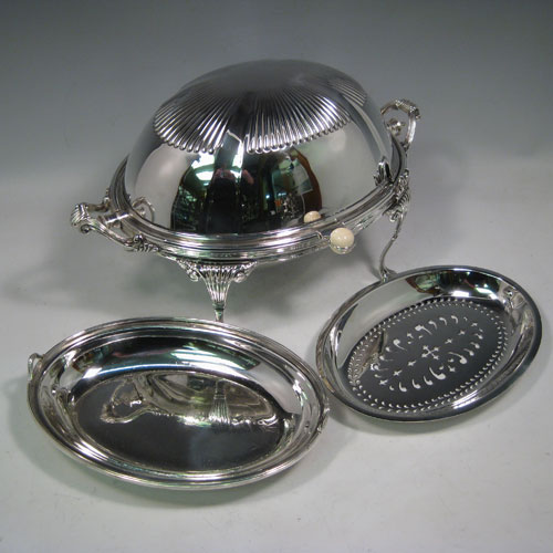 Antique Victorian silver-plated breakfast dish with revolving lid, original liners, and having hand-chased half-fluted body, sitting on four cast fluted feet. Made by the Mappin Brothers of Sheffield in ca. 1890. Height 21 cms (8.25 inches), length 35.5 cms (14 inches), width 21.5 cms (8 inches).