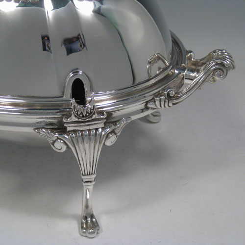 Antique Victorian silver-plated breakfast dish with revolving lid, original liners, and having hand-chased half-fluted body, sitting on four cast fluted feet. Made by the Mappin Brothers of Sheffield in ca. 1890. Height 21 cms (8.25 inches), length 35.5 cms (14 inches), width 21.5 cms (8 inches).