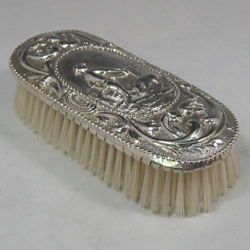 Antique Georgian sterling silver clothes brush made in London in 1773. A very rare piece chased with a pastoral scene. Length 15 cms.