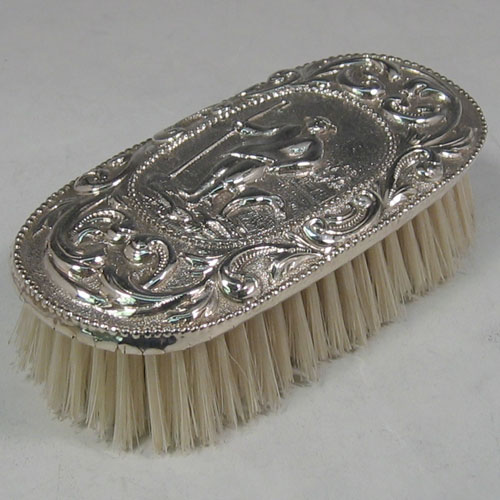    Antique Georgian sterling silver clothes brush made in London in 1773. A very rare piece chased with a pastoral scene. Length 12 cms.