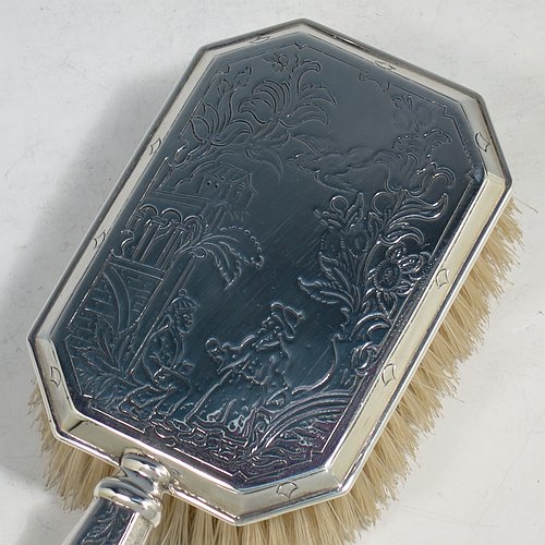 An Antique Sterling Silver hand hair brush, being a copy of a Queen Anne set, having an elongated hexagonal body with panelled handle, all hand-engraved in a Chinoiserie style, and with original bristles. Made by D. & J. Welby of London in 1915. The dimensions of this fine hand-made antique silver hair brush are length 25 cms (9.75 inches), and width 9 cms (3.5 inches).   