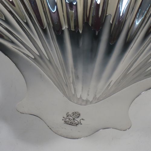 A very handsome Antique Georgian Sterling Silver butter shell, having a hand-chased traditional scallop shape, and sitting on two cast conch shell feet. Made by William Plummer of London in 1764. The dimensions of this fine hand-made antique silver butter shell are length 14 cms (5.5 inches), width 12 cms (4.75 inches), and with a weight of approx. 87g (2.8 troy ounces). Please note that this item is crested.  