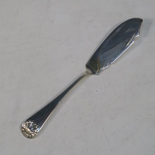 A very handsome Antique Victorian Sterling Silver butter shell dish and butter knife, having a hand-chased scalloped body, and sitting on three cast conch-shell feet. The butter shell made by Francis Higgins of London in 1885, and the butter knife made by Charles Boyton of London in 1887. The dimensions of this fine hand-made antique silver butter dish shell are length 12 cms (4.75 inches), width 10 cms (4 inches), and the total weight including knife is approx 98g (3.2 troy ounces).  