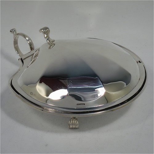 A very handsome and unusual Sterling Silver covered butter shell dish, having a hand-chased scalloped body, a hinged cover with a cast thumb-piece and knife slot, with a ring side-handle, a frosted cut removable liner, and all sitting on three cast reeded feet. Made by Henry Matthews of Birmingham in 1922. The dimensions of this fine hand-made silver butter dish shell are length 16.5 cms (6.5 inches), width 14 cms (5.5 inches), and it weighs approx 179g (5.7 troy ounces).    