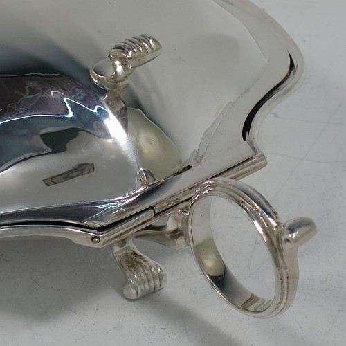 A very handsome and unusual Sterling Silver covered butter shell dish, having a hand-chased scalloped body, a hinged cover with a cast thumb-piece and knife slot, with a ring side-handle, a frosted cut removable liner, and all sitting on three cast reeded feet. Made by Henry Matthews of Birmingham in 1922. The dimensions of this fine hand-made silver butter dish shell are length 16.5 cms (6.5 inches), width 14 cms (5.5 inches), and it weighs approx 179g (5.7 troy ounces).    