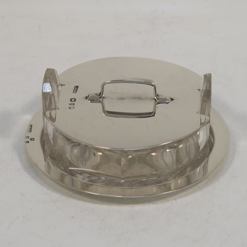 A very unusual Antique Victorian Sterling Silver and crystal butter dish and cover in an Arts and Crafts style, having a panelled crystal body with two side-handles, a lift-off plain round cover with handle, and all sitting in a plain round plate with a flat base. This elegant antique silver butter dish and cover was made by John Grinsell of London in 1893. The dimensions of this fine hand-made antique silver butter dish are diameter 8.5 cms (3.3 inches), height width 11 cms (4.25 inches), height 3.5 cms (1.3 inch), with a total weight of approx. 60g (2 troy ounces).   