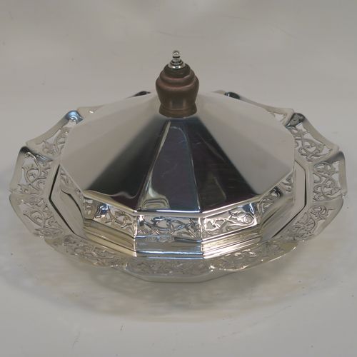 A very pretty Sterling Silver and crystal butter dish and cover, having a panelled lift-off lid with wooden finial, an original crystal liner with star-cut base sitting inside a panelled dish with hand-cut floral border and flat base. This beautiful antique silver butter dish and cover was made by Emile Viner of Sheffield in 1936. The dimensions of this fine hand-made silver butter dish and cover are diameter 15 cms (6 inches), height 8.5 cms (3.3 inch), with a total weight of approx. 286g (9.2 troy ounces).   