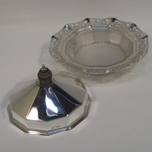 A very pretty Sterling Silver and crystal butter dish and cover, having a panelled lift-off lid with wooden finial, an original crystal liner with star-cut base sitting inside a panelled dish with hand-cut floral border and flat base. This beautiful antique silver butter dish and cover was made by Emile Viner of Sheffield in 1936. The dimensions of this fine hand-made silver butter dish and cover are diameter 15 cms (6 inches), height 8.5 cms (3.3 inch), with a total weight of approx. 286g (9.2 troy ounces).   