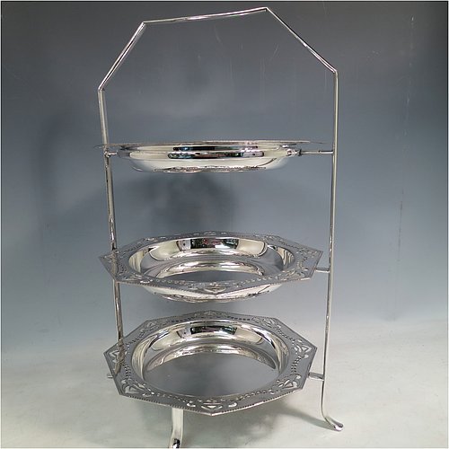 An Antique Edwardian very pretty silver-plated cake stand, having three removable octagonal dishes with hand-pierced borders showing pairs of Swallows, all held in a plain wire-work frame with a carrying handle and four scroll feet. All made in ca. 1900. The dimensions of this fine hand-made antique silver-plated cake stand are height 43 cms (17inches), width 30.5 cms (12 inchs), and the diameter of the inside of the dishes is 18 cms (7 inches).   