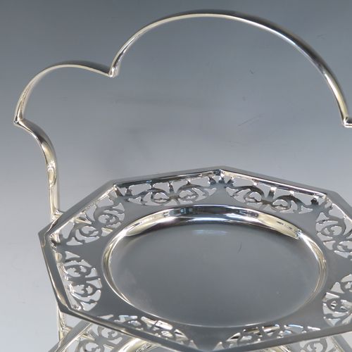 A very pretty Antique Edwardian silver plated three-tier cake stand, having a suite of three removable octagonal plates with hand-pierced scroll borders, sitting within a frame with four scroll-work feet. This beautiful antique silver-plated cake stand was made in ca. 1910. The dimensions of this fine hand-made antique silver-plated cake stand are height 41 cms (16 inches), width at feet 30.5 cms (12 inches), and diameter of plates 21.5 cms cms (8.5 inches).   